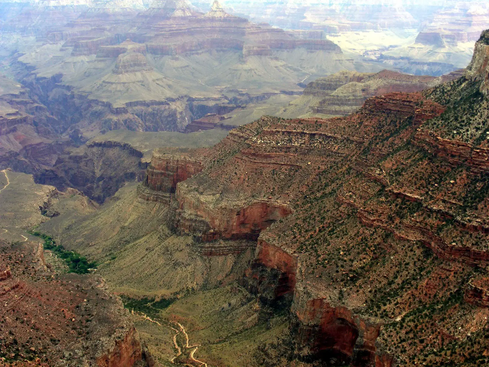 Parois rouges en terrasses et sentier au fond d’une vallée du Grand Canyon en Arizona
